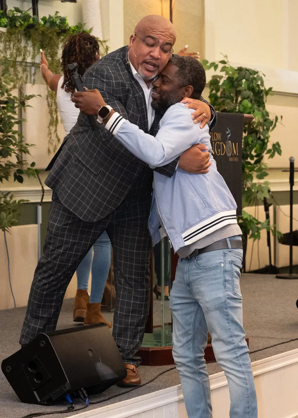 Apostle Israel Peña embracing a congregant